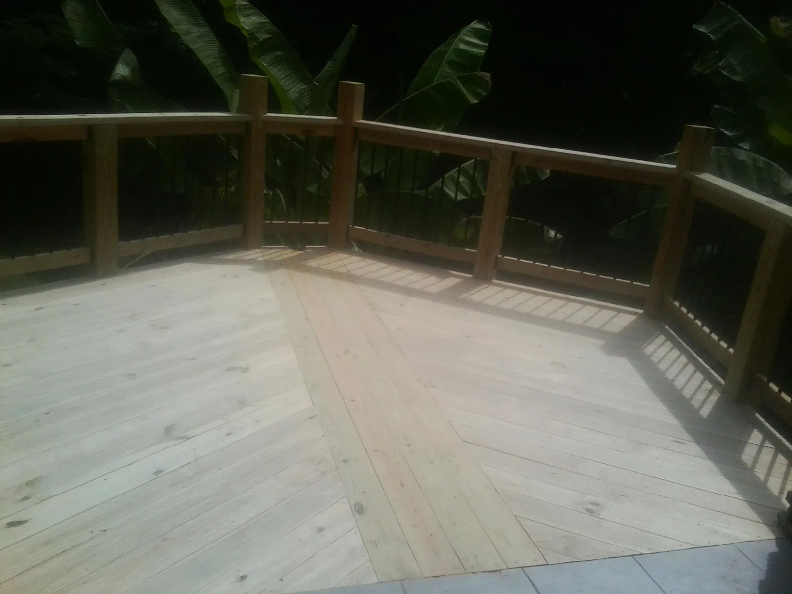 New wood deck and railing built off the back of a home in Clarkton
